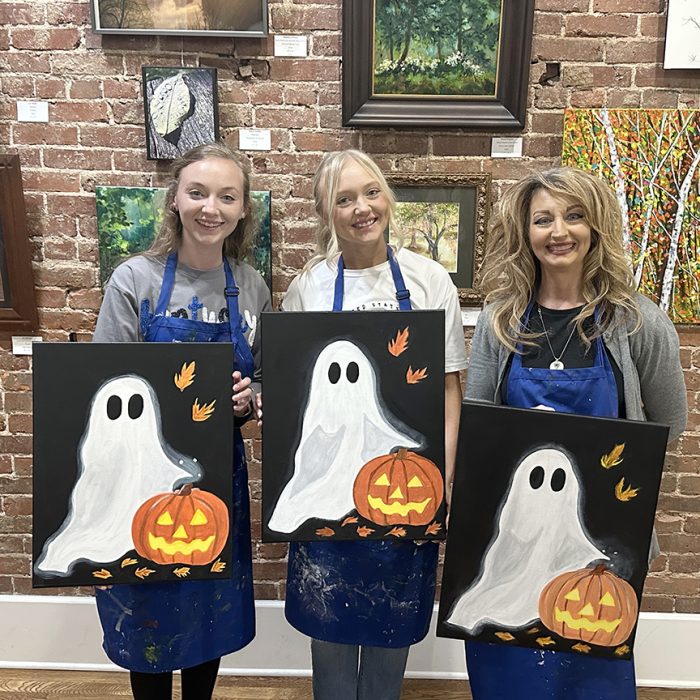 Three women holding paintings they made at Art Center of the Bluegrass in Danville, Kentucky